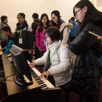 Students were playing instruments at exhibition Hall.